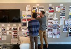 People pinning work to a wall
