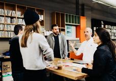 People standing around table