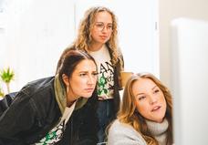 Ladies looking into computer monitor