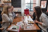 four people sitting at a table insight, playing Medium