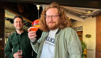 Dokota standing with a beverage