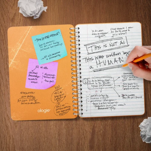 An open spiral notebook filled with handwritten notes about AI and emotional intelligence, including the phrase “This is not AI. This was written by a human.”